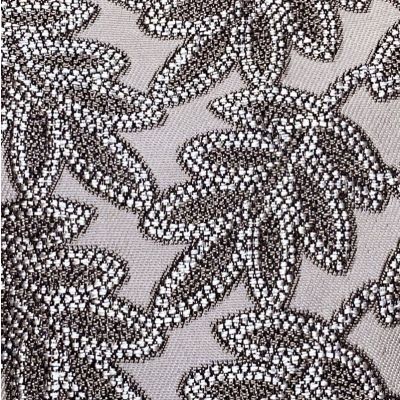 Polyester blend fabric with taupe background and charcoal and light gray relief pattern